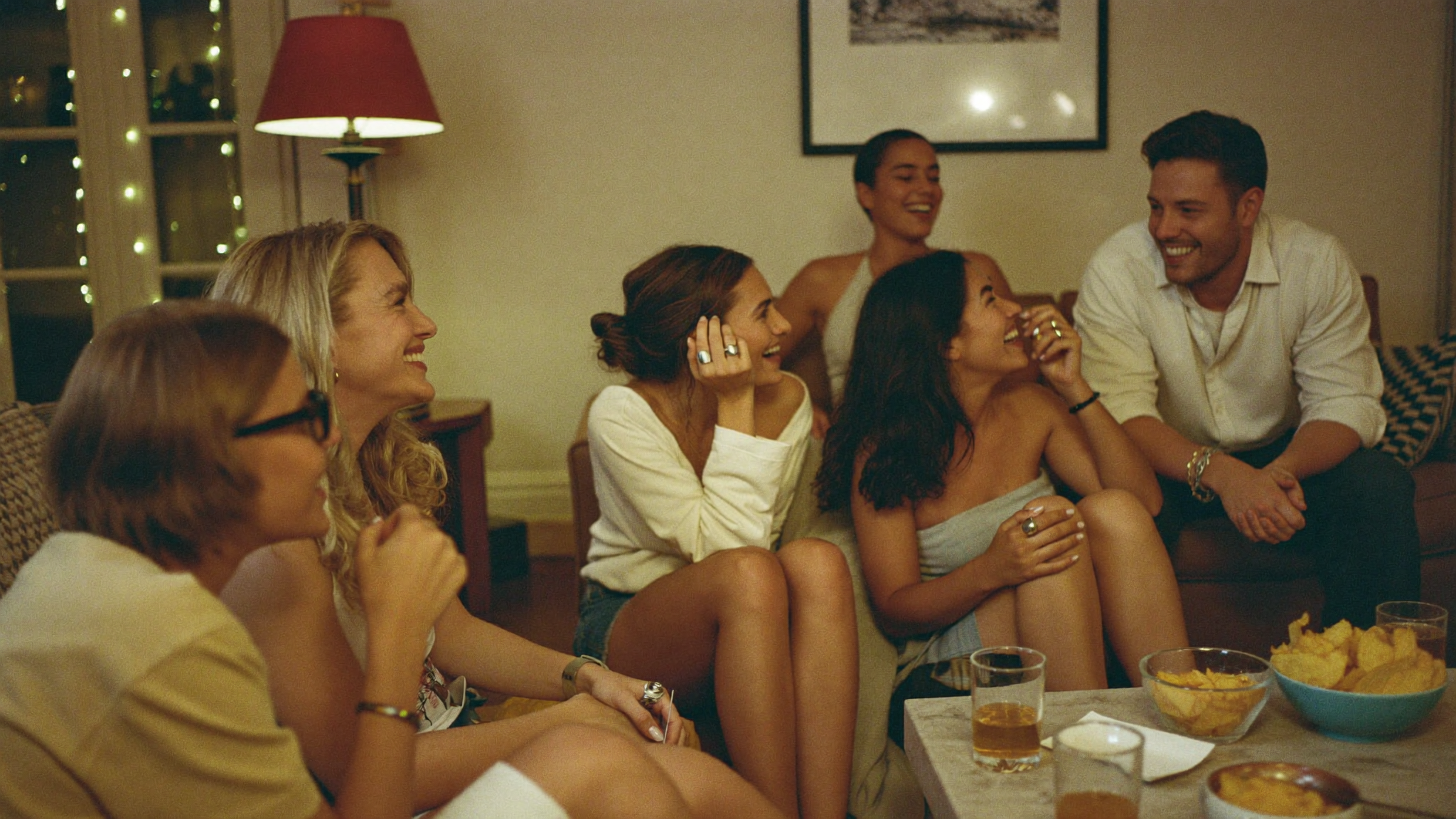 A small group of people laughing together in a cosy living room